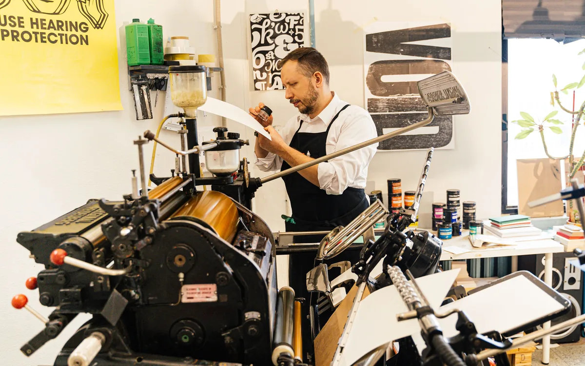 A press operator checking a print run
