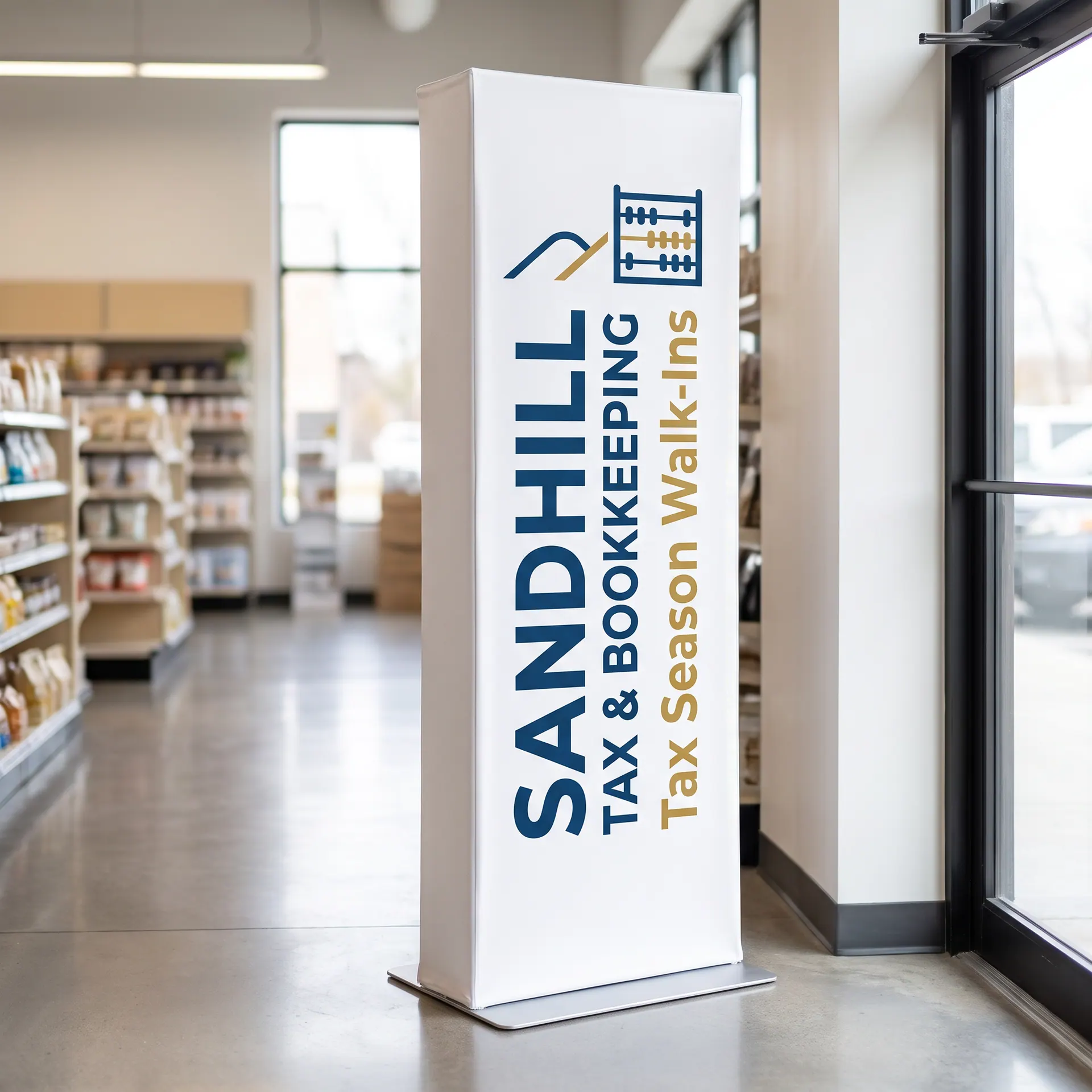 Slim freestanding tension fabric banner tower, printed on both sides, shown with a sample design: in a bright store aisle near the entrance